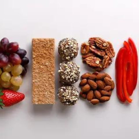 A vibrant assortment of nutrient-rich fruits, nuts, and vegetables, showcasing the benefits of eating healthy snacks for vitality and well-being.